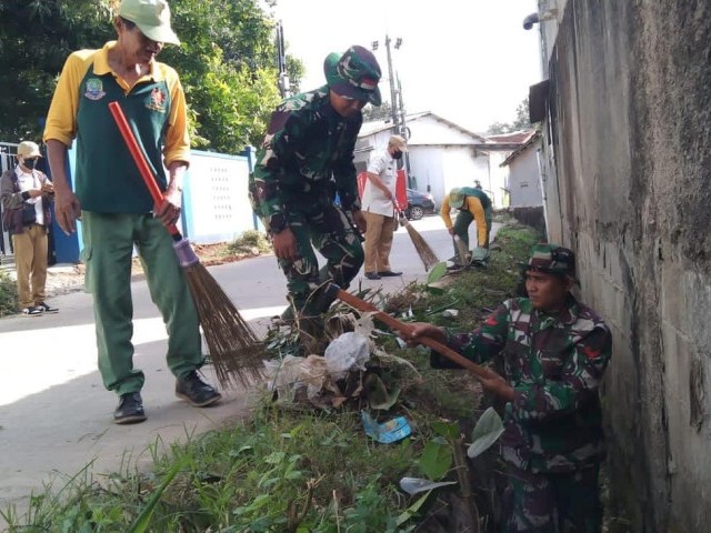 Kebersamaan Babinsa Bersama Warga Laksanakan Karya Bakti Bersihkan Jalan Lingkungan